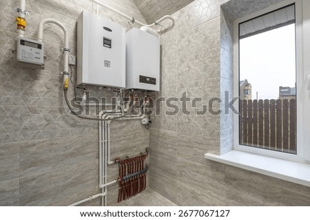 A modern heating system with two boilers and neatly laid pipes in a residential utility room.