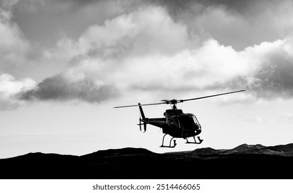 Modern helicopter landing in a remote volcanic landscape in Iceland. Helicopter in front of a dramatic cloudy sky with rotating rotor, landing skids. Black and white shot with strong contrasts. - Powered by Shutterstock