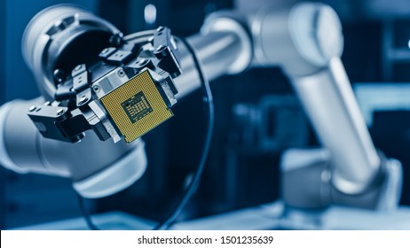 Modern High Tech Authentic Robot Arm Holding Contemporary Super Computer Processor. Industrial Robotic Manipulator End Effector Holding CPU Chip - Shutterstock ID 1501235639