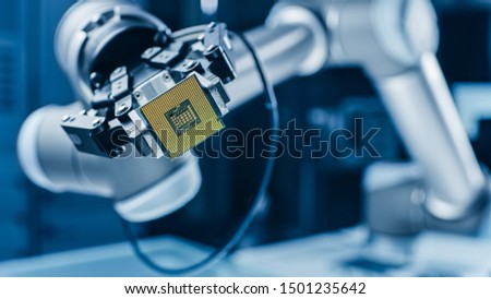 Modern High Tech Authentic Robot Arm Holding Contemporary Super Computer Processor. Industrial Robotic Manipulator End Effector Holding CPU Chip