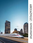 Modern High-Speed Train Gliding Past Skyscrapers at Sunset  