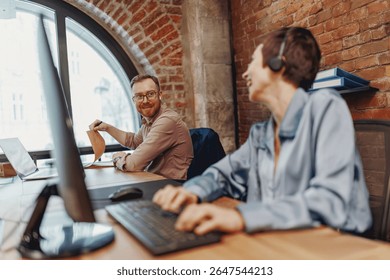 In a modern, hightech workspace, two dedicated professionals are collaborating using cuttingedge technology