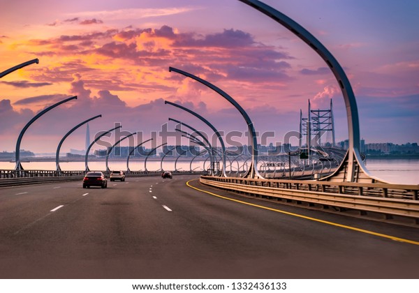 Modern highway. Road with cars in the evening.\
Highway at sunset. Cars drive in the direction of the sunset.\
Highway. Highway at\
sunset.