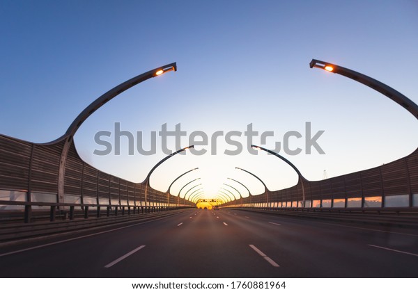 modern highway toll road at\
sunset
