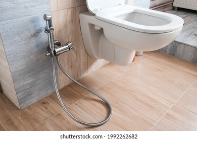 Modern home bathroom interior design with white, toilet or bidet with chrome shower head