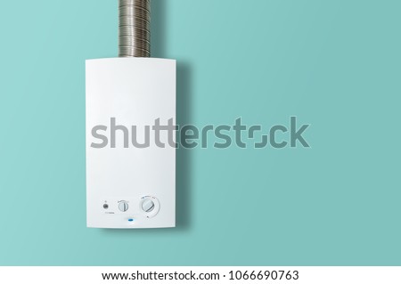Modern home gas boiler, water heater. An isolated gas stove on a pastel turquoise background. Water heating, ecology. Concept lifestyle.