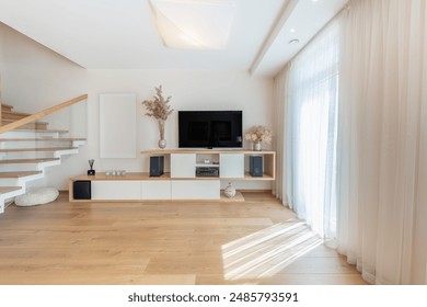 Modern Home Living Room Interior. Luxurious Stylish Modern Apartment. Scandinavian Design. TV Screen, Sunlight, Windows and Curtains. Wide Angle