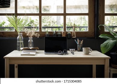 Modern home office creative space perfect for working from home lifestyle with laptop on the desk and sofa in the living room, Quarantine isolation during the Coronavirus (COVID-19) health crisis