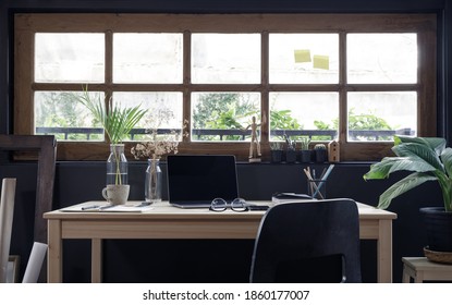 Modern home office creative space perfect for working from home lifestyle with laptop on the desk and sofa in the living room, Quarantine isolation during the Coronavirus (COVID-19) health crisis - Shutterstock ID 1860177007