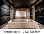 A modern home theater room with comfortable seating, a large screen, and elegant wood paneling and black acoustic walls.