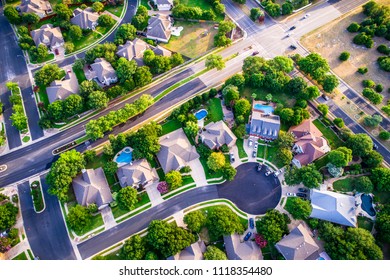 Modern homes and houses in suburb. High aerial view above thousands of homes north of Austin , Texas in Round Rock Suburbia sunset colors of new development neighborhood straight down angle cul de sac