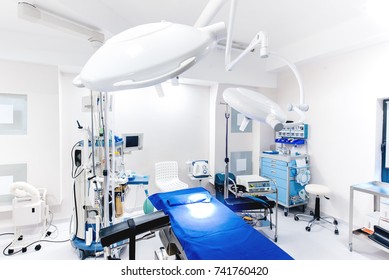 Modern hospital interior. Details of medical equipment with lamps and operating table