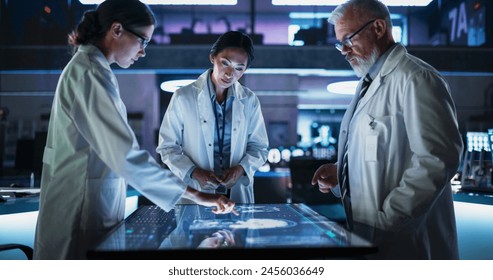 Modern Hospital Medical Research Center: Diverse Colleagues Gathered Around Interactive Touch Screen Table With MRI Scans Of Brain On Display. Doctors Discussing Rehabilitation Solutions After Stroke. - Powered by Shutterstock