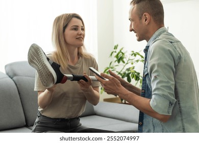 Modern Hospital Physical Therapy: Doctor Uses Tablet Computer, Helps Patient with Injury Walk on Treadmill Wearing Advanced Robotic Exoskeleton Legs. Physiotherapy Rehabilitation Technology - Powered by Shutterstock