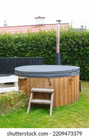 Modern Hot Tub With Wooden Frame In A Garden