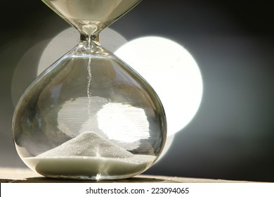 Modern Hourglass -- Sand Trickling Through The Bulbs Of A Crystal Sand Glass. Every Second Counts. Symbol Of Time. Countdown. Sand Clock.