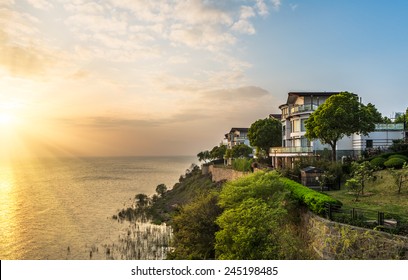 Modern House Aside The Lake In Sunset.