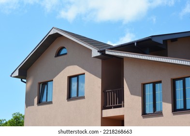 Modern House With Asphalt Shingles Roof,  Balcony, Rain Gutter Pipeline And Soffit Boards Outdoors.