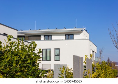 modern house building rooftop at april spring month in south germany - Shutterstock ID 1406745527