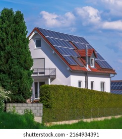 Modern house with photovoltaic solar cells on the roof for alternative energy production - Shutterstock ID 2164934391