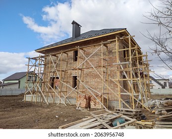 Modern House Roof Construction With Scaffold Pole Platform. New Build Domestic Building.