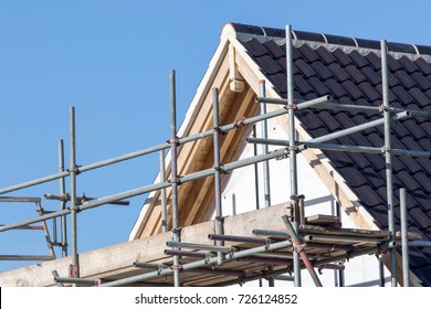 Modern House Roof Construction With Scaffold Pole Platform. New Build Domestic Building.