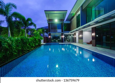 Modern house with swimming pool at night