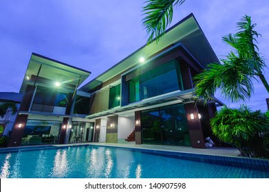 Modern House With Swimming Pool At Night