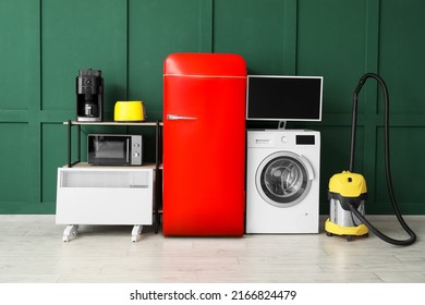 Modern Household Appliances Near Green Wall In Room