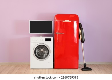 Modern Household Appliances Near Pink Wall In Room