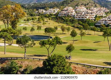 Modern Houses And Green Golf Field On Mountains Against Cloudy Sky In Spain.Costa Del Sol. Andalusiya.