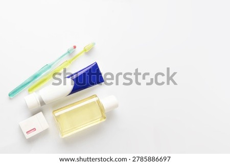 Modern hygiene essentials captured in soft light - toothpaste, toothbrush, floss and mouthwash - promoting oral freshness, health, and natural lifestyle aesthetics.