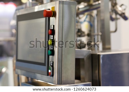 Modern industrial control panel with a touch screen. Selective focus.