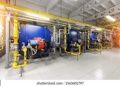 Modern industrial gas boiler room equiped for heating process. Heating gas boilers, pipelines, valves.