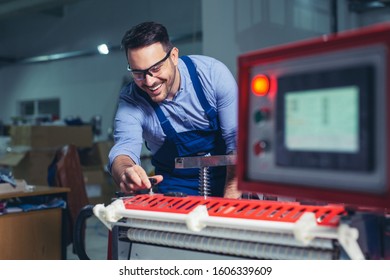 Modern industrial machine operator working in factory. Worker on the machine