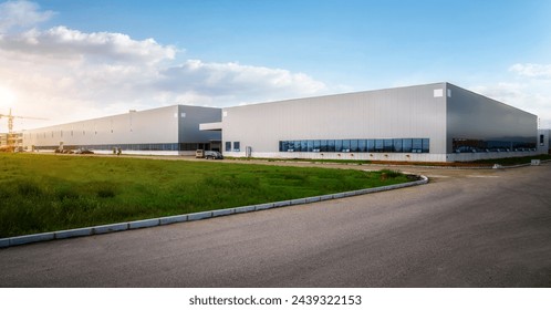 Modern Industrial Warehouse at Sunset with Clear Sky - Powered by Shutterstock