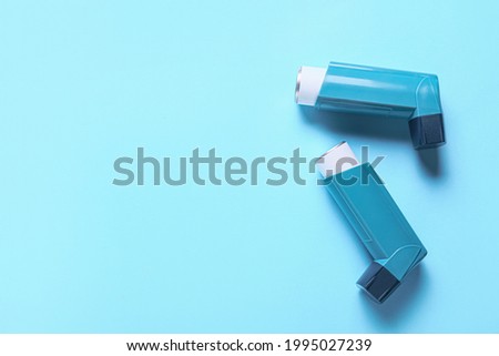 Modern inhalers on color background