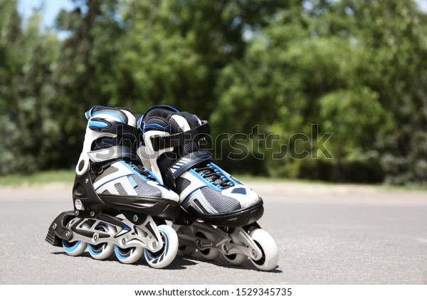 Modern\
inline roller skates in city park on sunny\
day