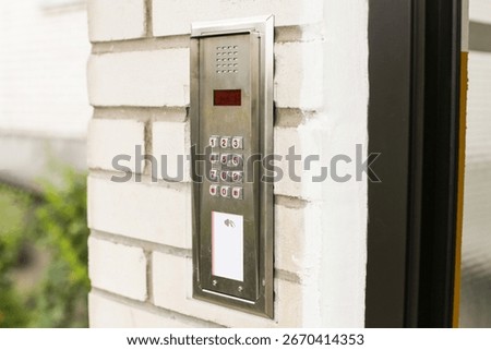 Modern intercom keypad with card reader on building wall. Secure access control system for apartments and offices. Electronic entry with buttons and RFID sensor. Safety technology for restricted entry