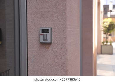 Modern intercom system installed on a smooth concrete wall