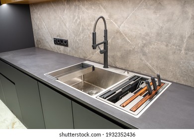 Modern interior of apartment. Luxury grey kitchen set. Huge sink. Built-in elements.