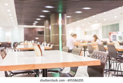 Modern interior of cafeteria or canteen with chairs and tables, nobody