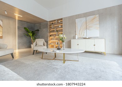 modern interior design of the living area in the studio apartment in warm soft colors. decorative built-in lighting and soft beige furniture