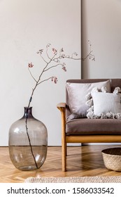 Modern interior design of living room with brown wooden sofa, pillows, rattan basket, glassy vase with flowers and elegant accessories. Beige and japandi concept. Stylish home staging. Template.  - Shutterstock ID 1586033542