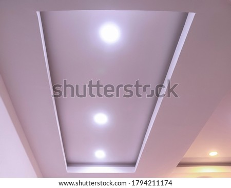 Modern interior design for living room, conference room and hotels. False ceiling co-ply design using gypsum or plaster of paris. Illuminated new home interior with false ceiling lighs.