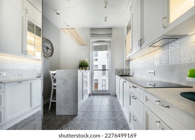 Modern interior design - open kitchen in the apartment in white finishing - Shutterstock ID 2276499169