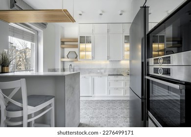 Modern interior design - open kitchen in the apartment in white finishing - Shutterstock ID 2276499171
