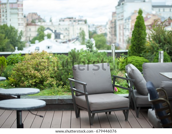 Modern interior design with\
sofa. Interior of Living Room. Green terrace on the roof of the\
house