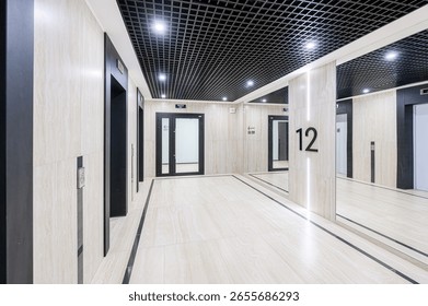 Modern interior with elevators, doors, and reflective surfaces. The ceiling is black grid, and the floor is tiled. Walls feature beige marble