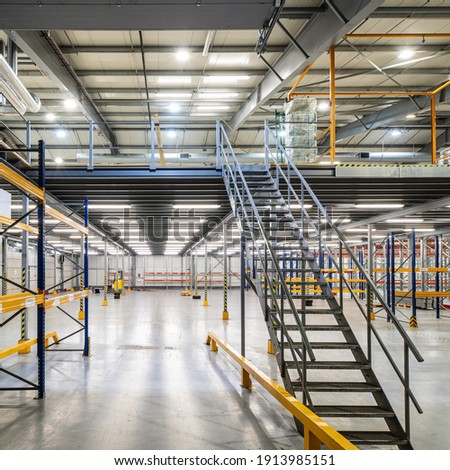 Similar – Image, Stock Photo Industrial warehouse staircase with a glimpse of neon light